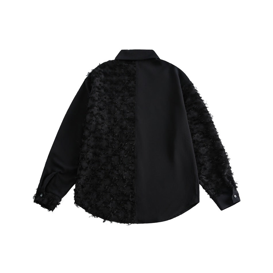Back view of a black button-up shirt with a smooth right panel and textured left panel and sleeves.