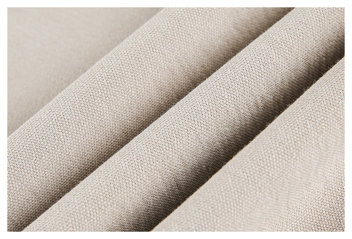 Close-up of the beige garment's textured knit arranged in soft folds.