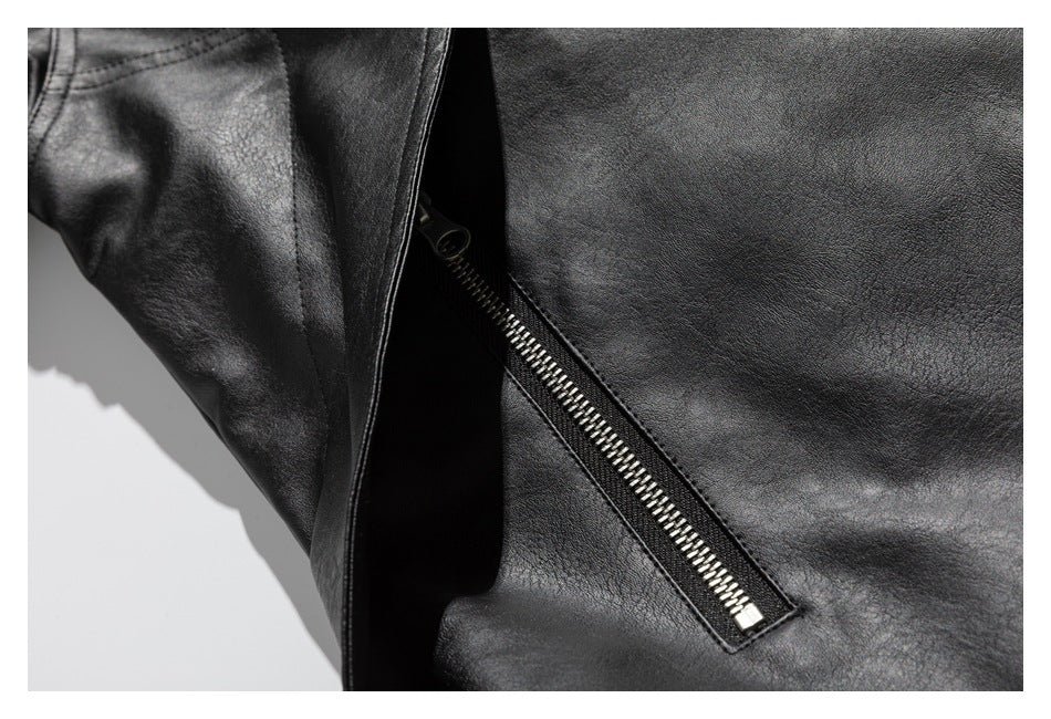 Close-up of a black jacket's angled silver zipper pocket and stitched seams.