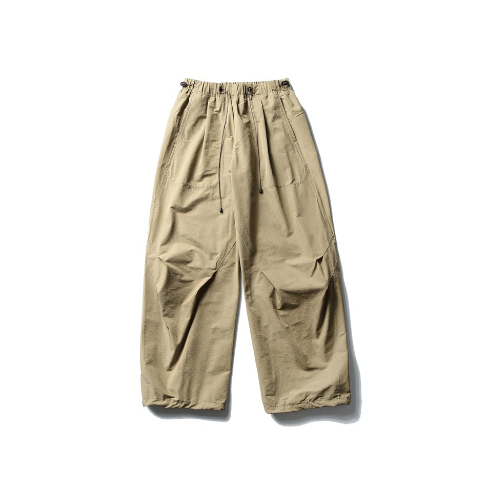 Camel wide-leg parachute pants with drawcord elastic waistband, flat lay front view