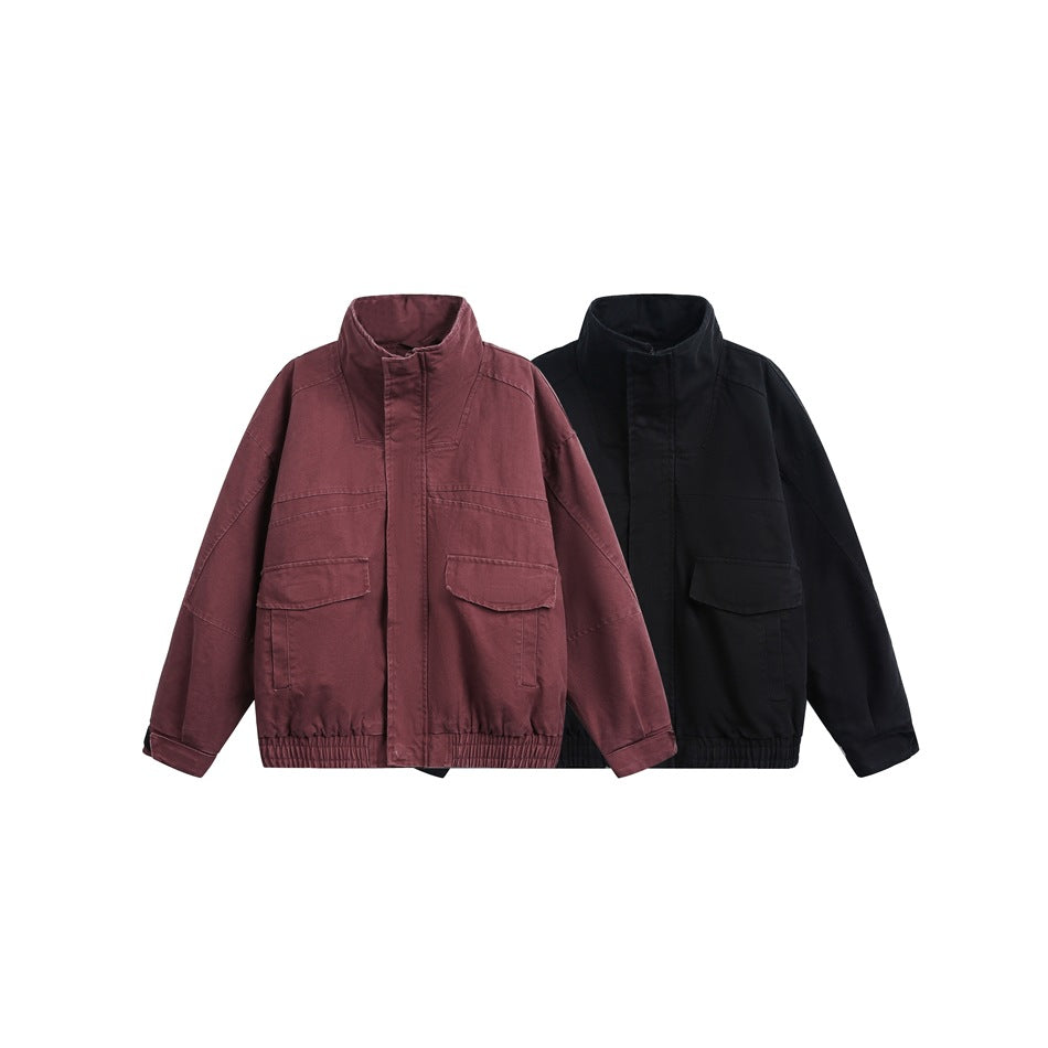 Front view of two stand-collar jackets in burgundy and black, with flap pockets and elastic hems.