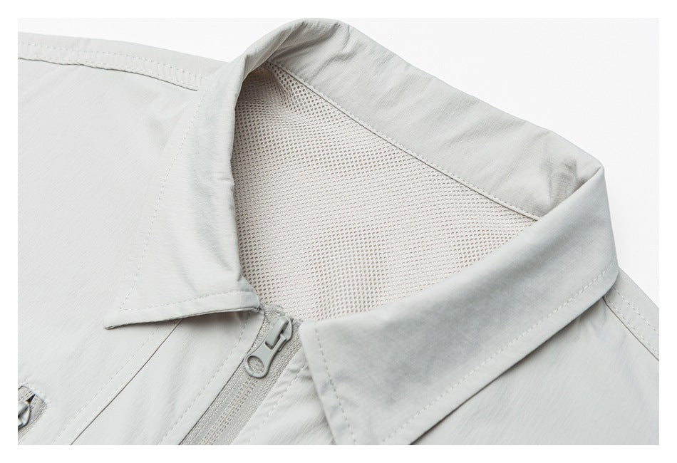 Close-up of a pale gray jacket collar, mesh lining, and front zipper.