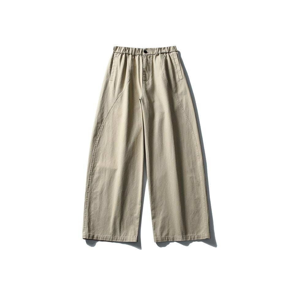 Khaki wide-leg pants laid flat, front view, with elastic waistband, button closure, side pockets and curved seams