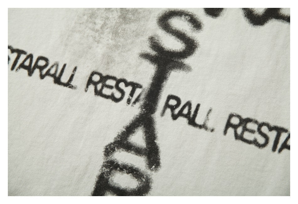 Extreme close-up of black English lettering printed across off-white fabric.
