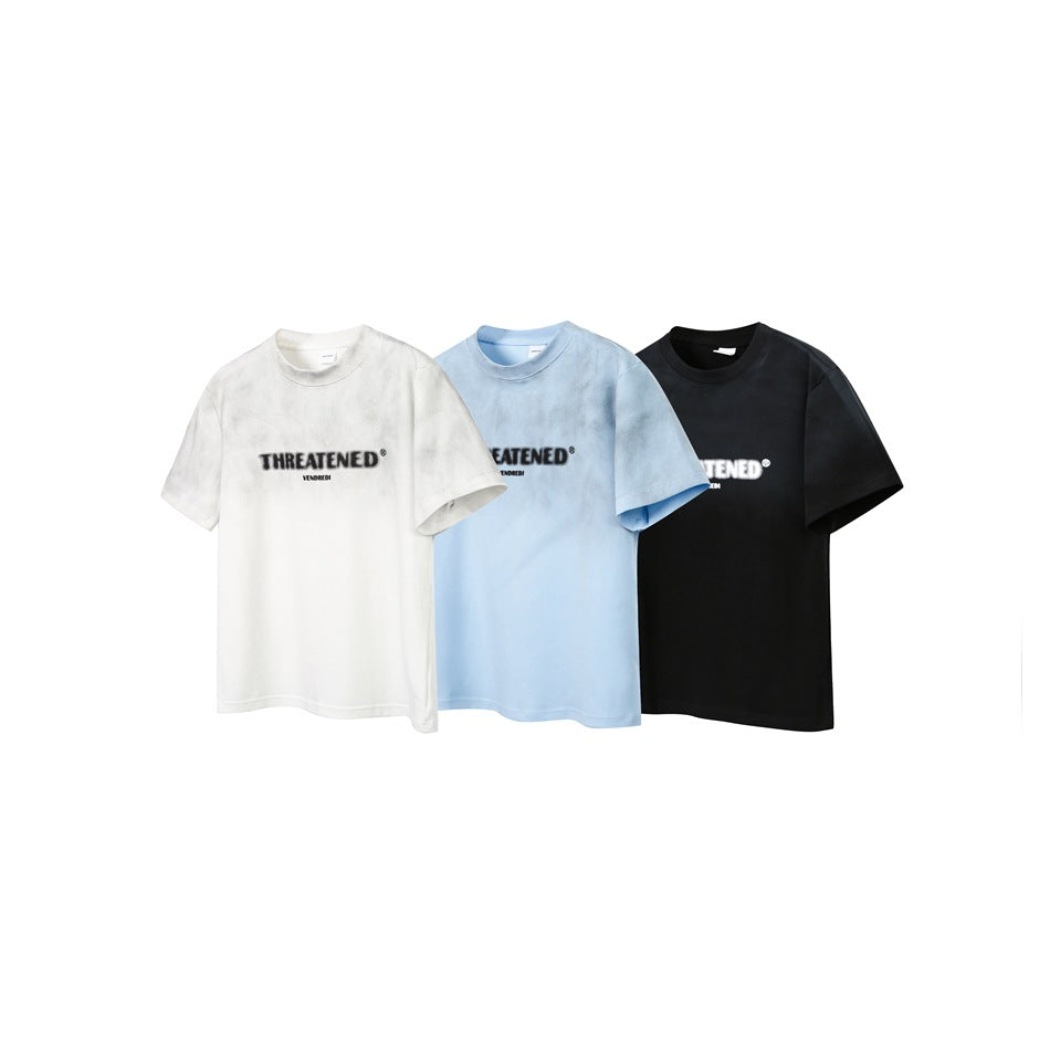Three short-sleeve crew-neck T-shirts in white, pale blue, and black, each with a centered chest logo.