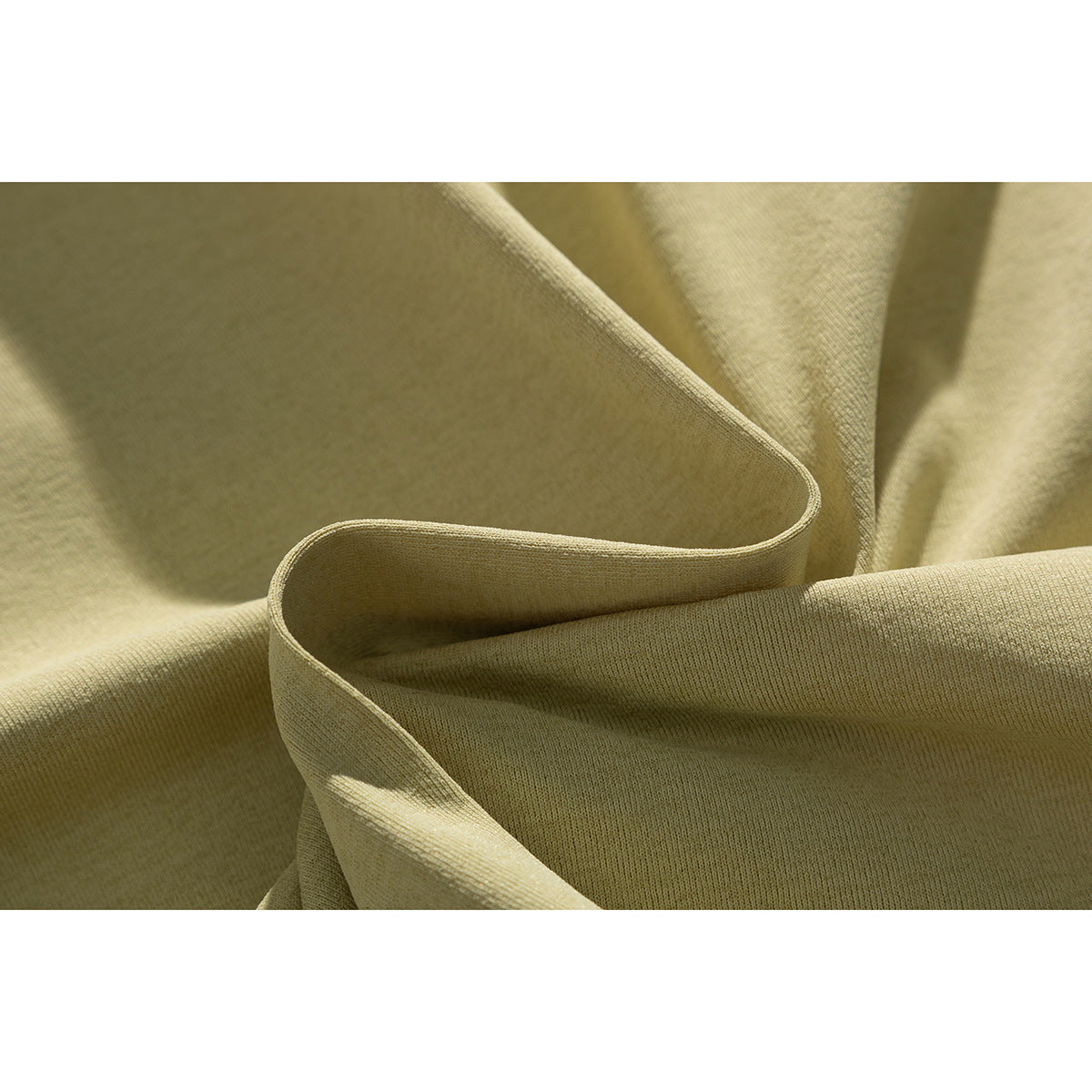 Close-up showing the knit surface and drape of pale khaki fabric.