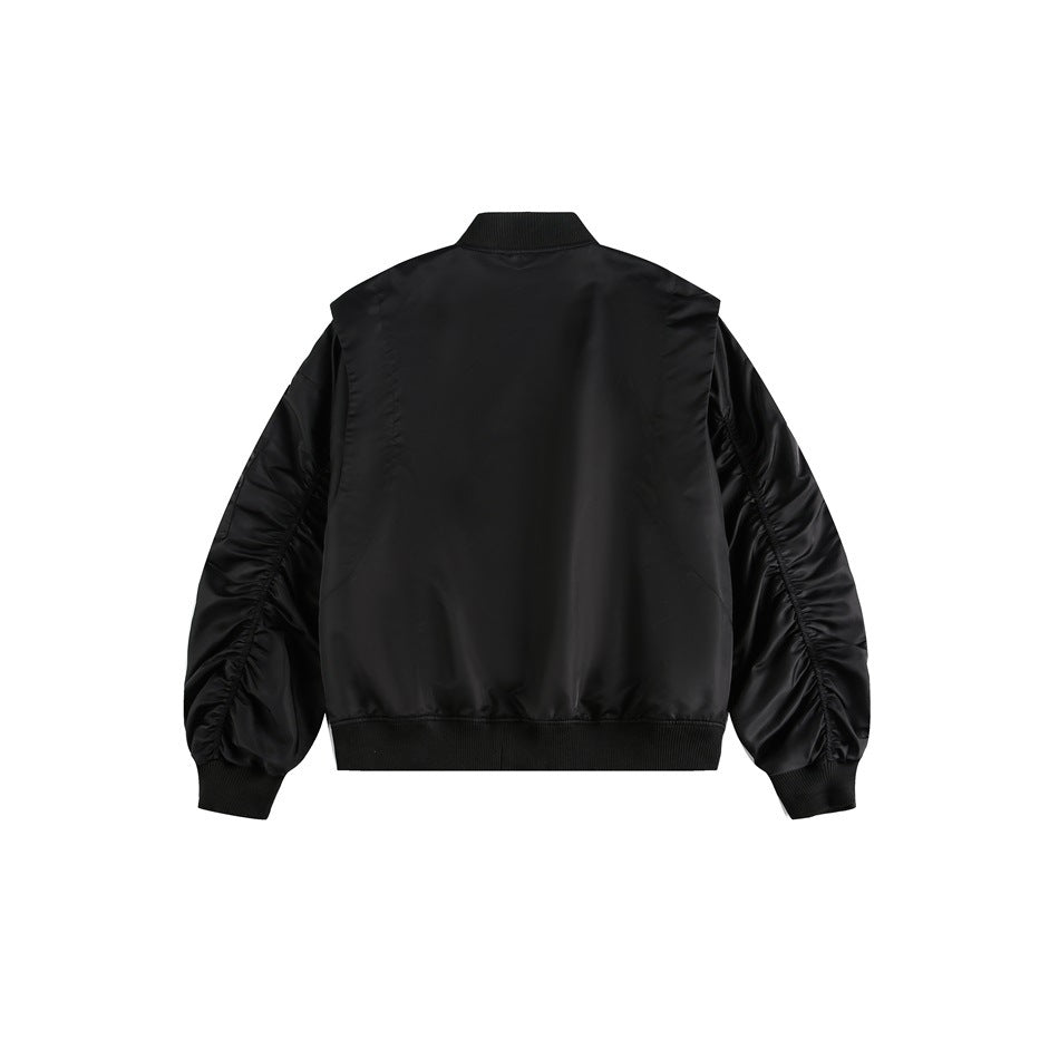 Back view of a black bomber jacket displayed flat against a white background, with gathered sleeves and ribbed trim.