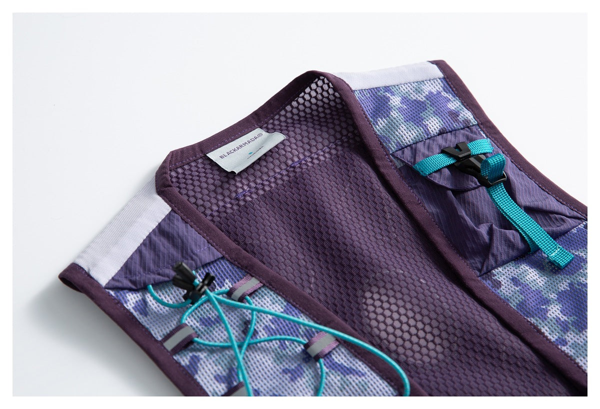 Close-up of purple mesh vest interior, patterned panels, turquoise cords and buckle; a sewn English-text label is visible.