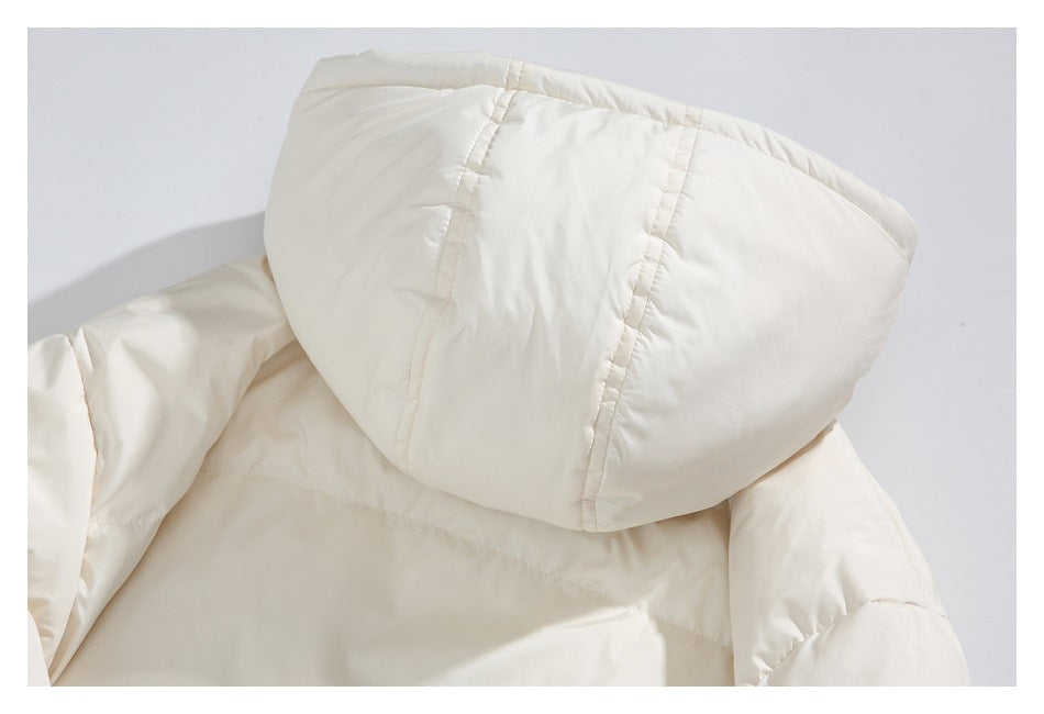 Close-up of the cream padded jacket's hood and stitched panels.