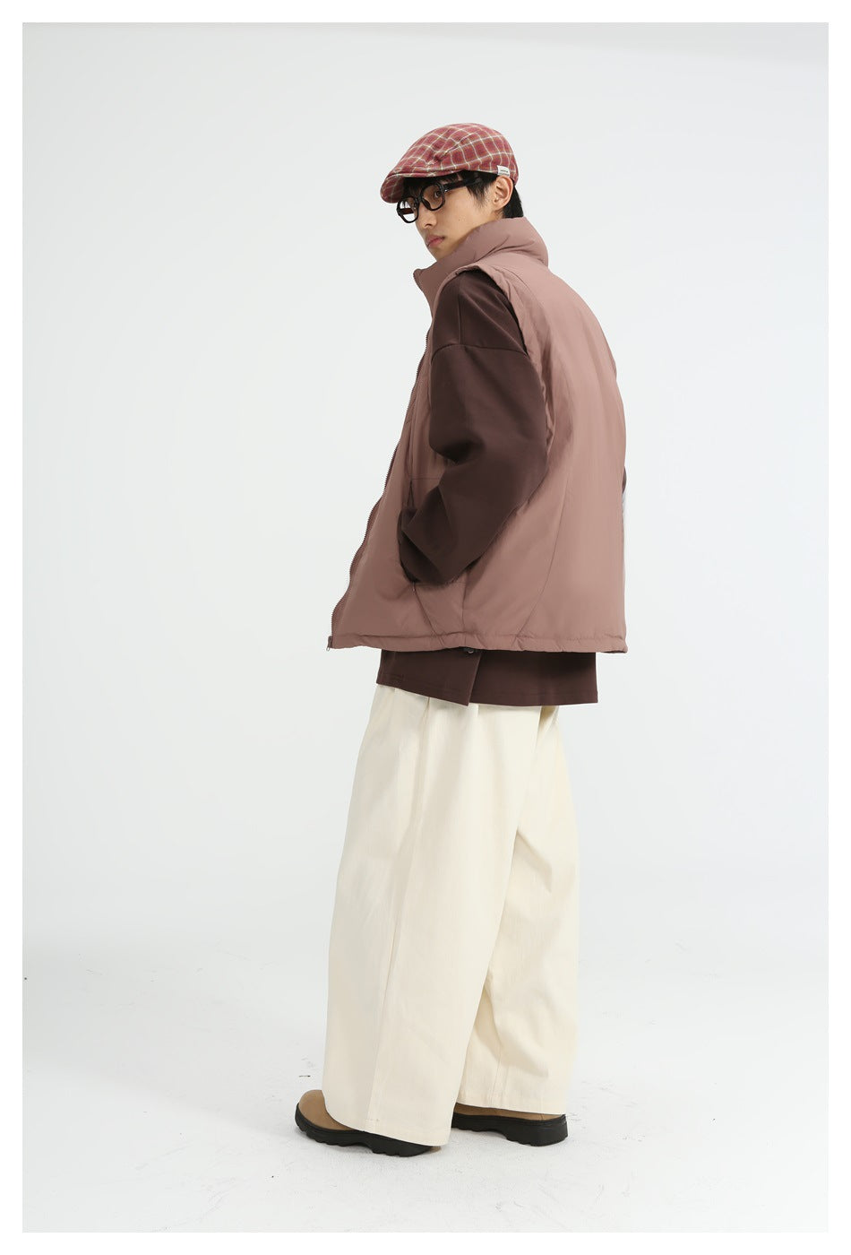 Model in dusty rose vest over a brown top with cream wide-leg pants, turned to show side and back view