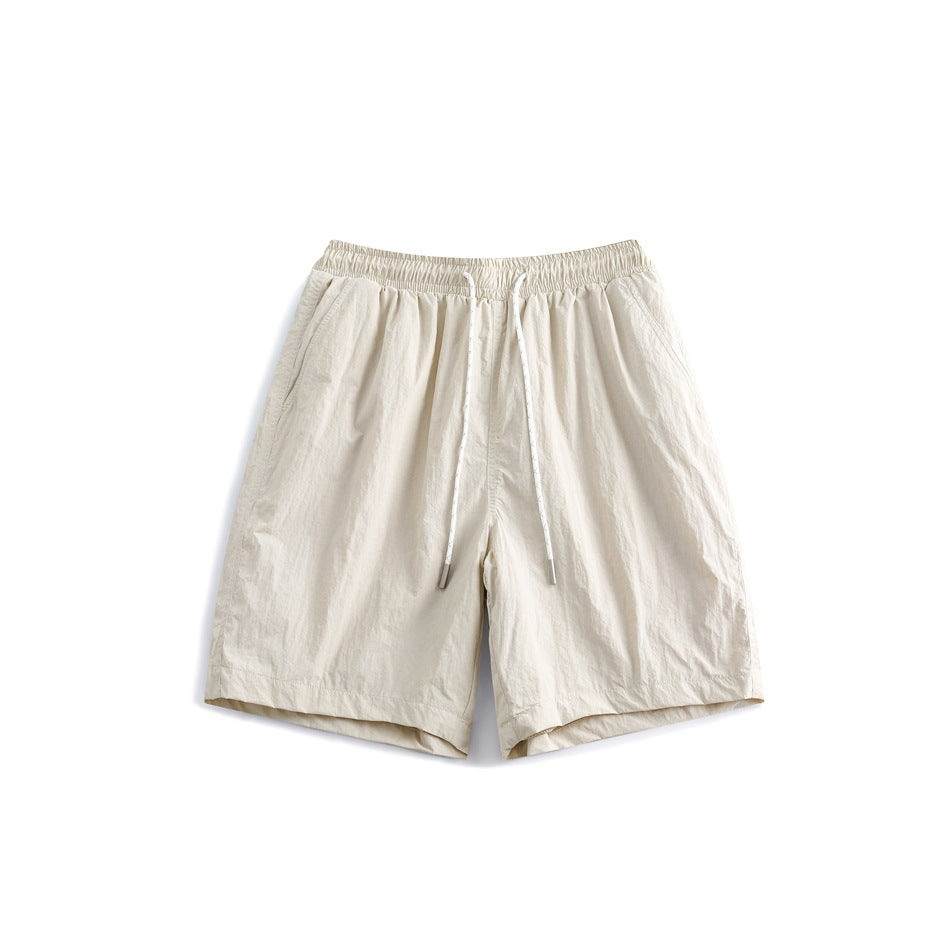 Off-white drawstring shorts with elastic waistband and side pockets, front flat view