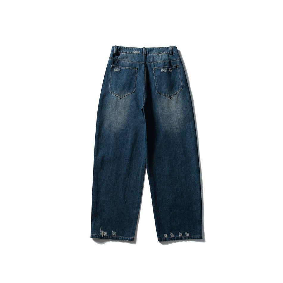 Back of blue washed wide-leg jeans with two patch pockets and frayed distressing at the hems, flat on white