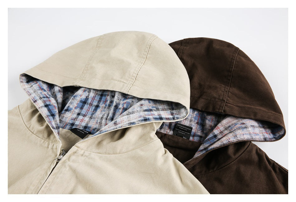 Close-up of beige and dark brown hooded jackets showing blue, gray, and red plaid hood linings.