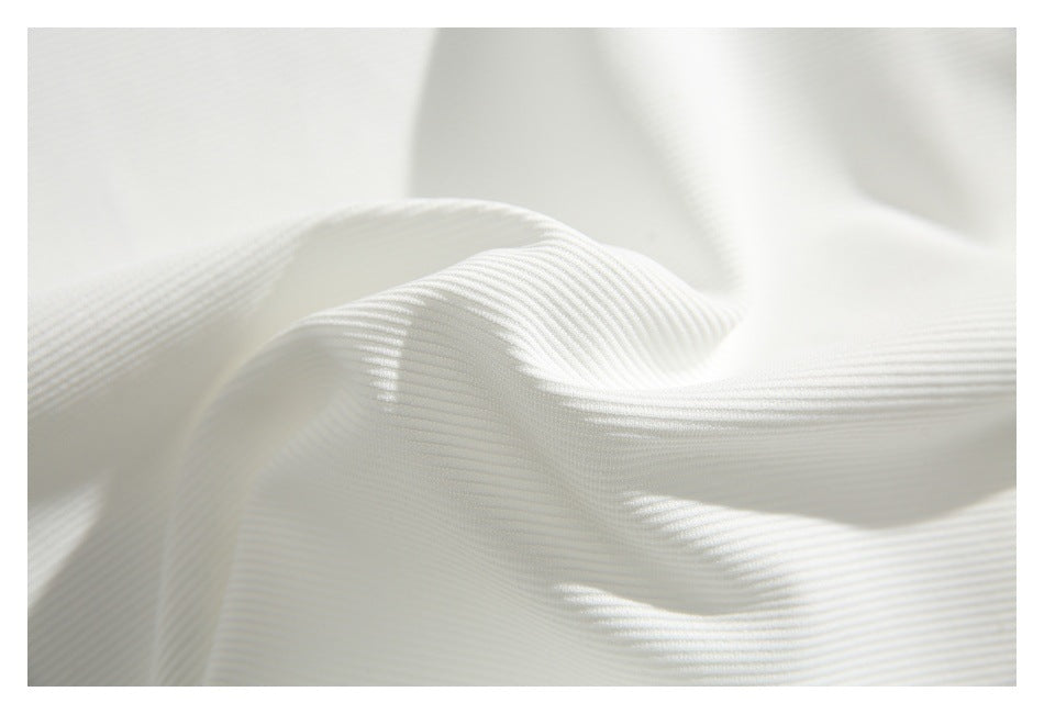 Close-up of white ribbed fabric draped to show its fine horizontal texture.