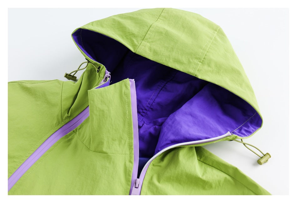 Close-up of the jacket's lime-green hood, purple lining, lavender zipper, and drawcord.