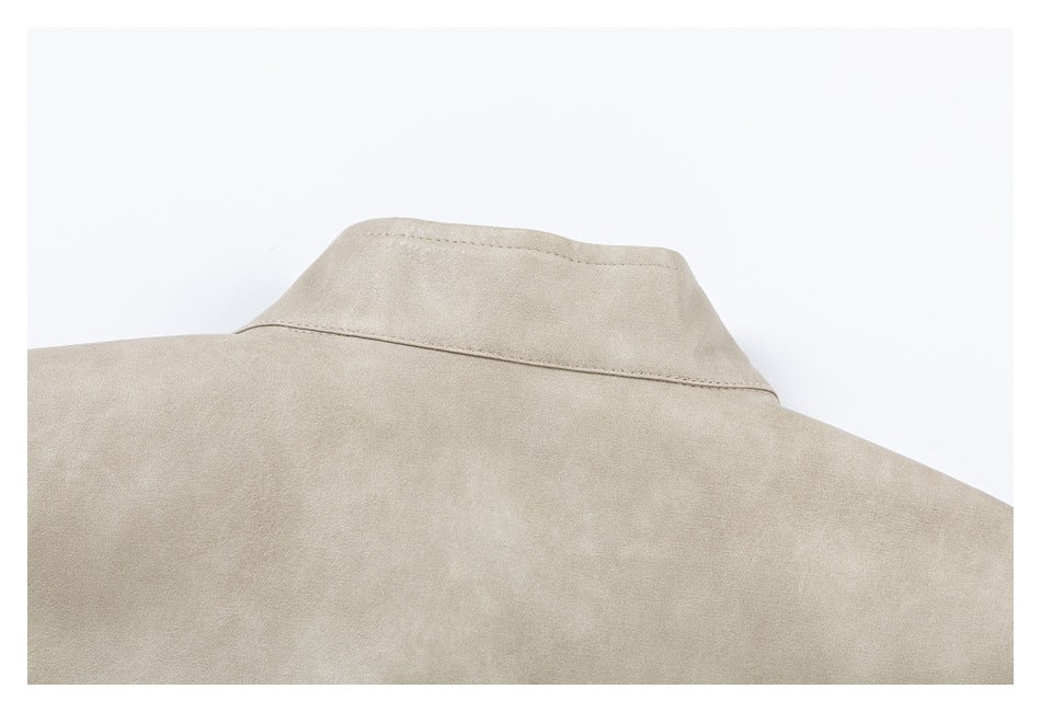 Close-up of the back stand collar and shoulder seams on a light taupe coat.