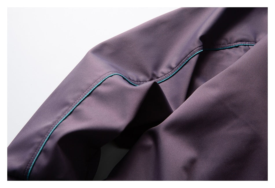 Close-up of curved teal piping along a seam on purple garment fabric.