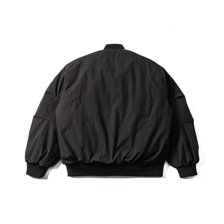 Back view of a black jacket with a ribbed collar, cuffs and hem, laid flat on white.