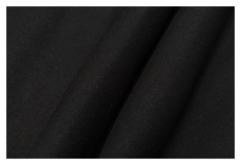 Close-up of black fabric showing its fine knit texture and folds.