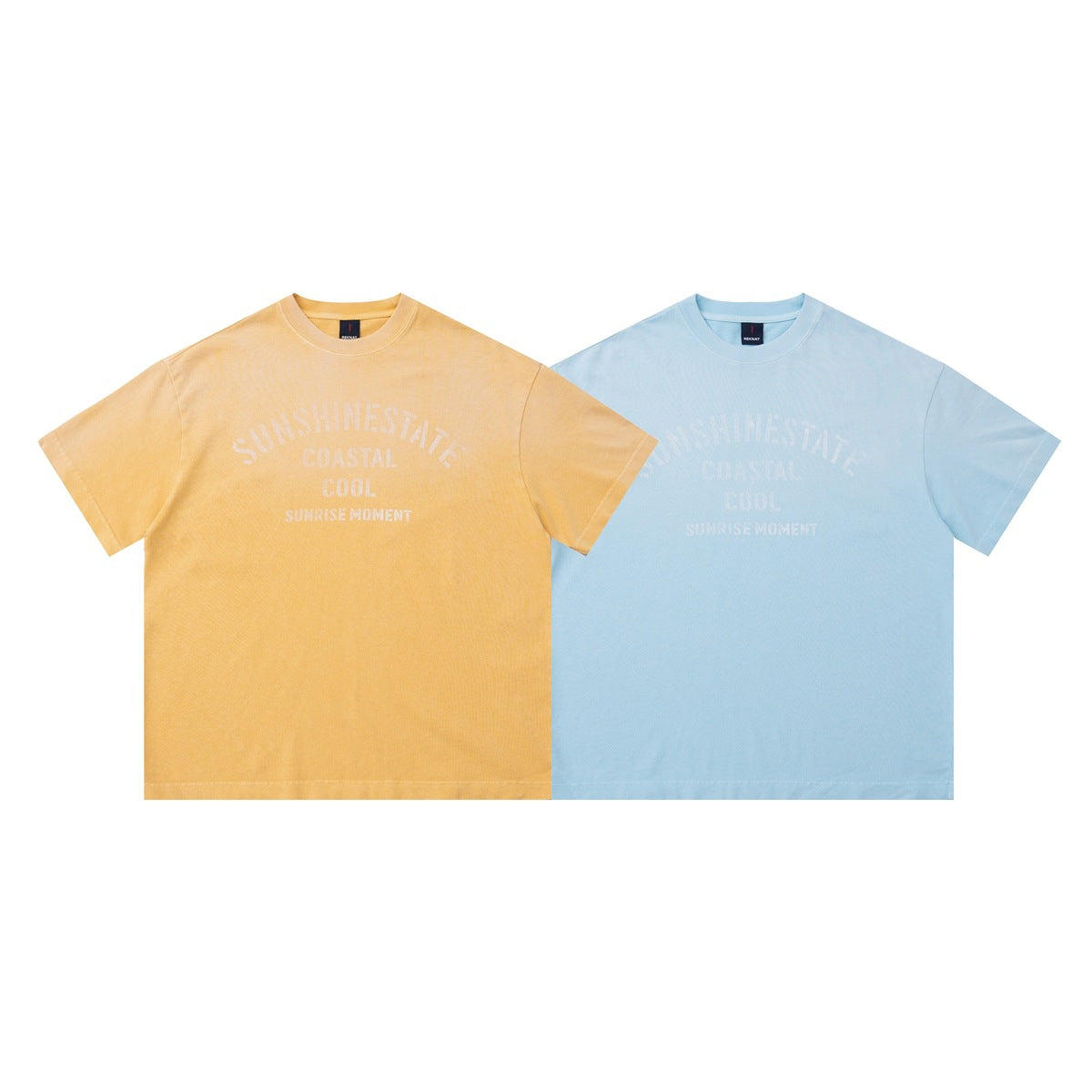 Front view of two crew-neck T-shirts, one golden yellow and one light blue, with matching pale chest text.