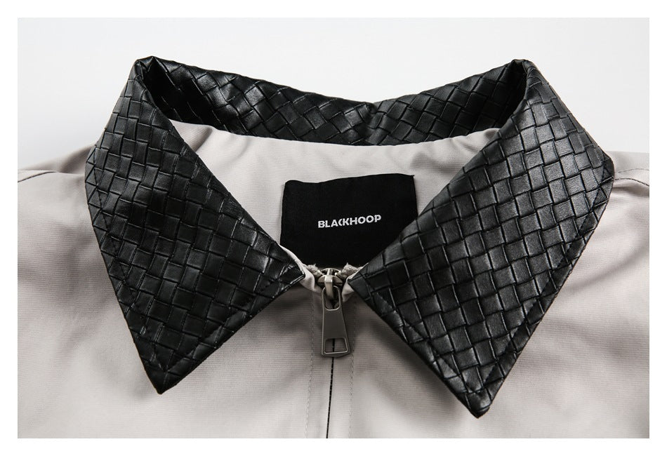 Light gray jacket collar close-up with black woven panels, zipper, and sewn-in BLACKHOOP label.
