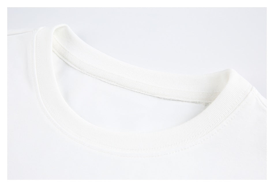 Close-up of a white T-shirt's ribbed crew neck and inner stitching.