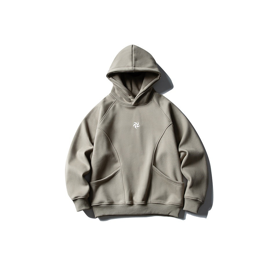 Gray hooded sweatshirt flat lay with curved seams, front pouch pockets and small white pinwheel logo