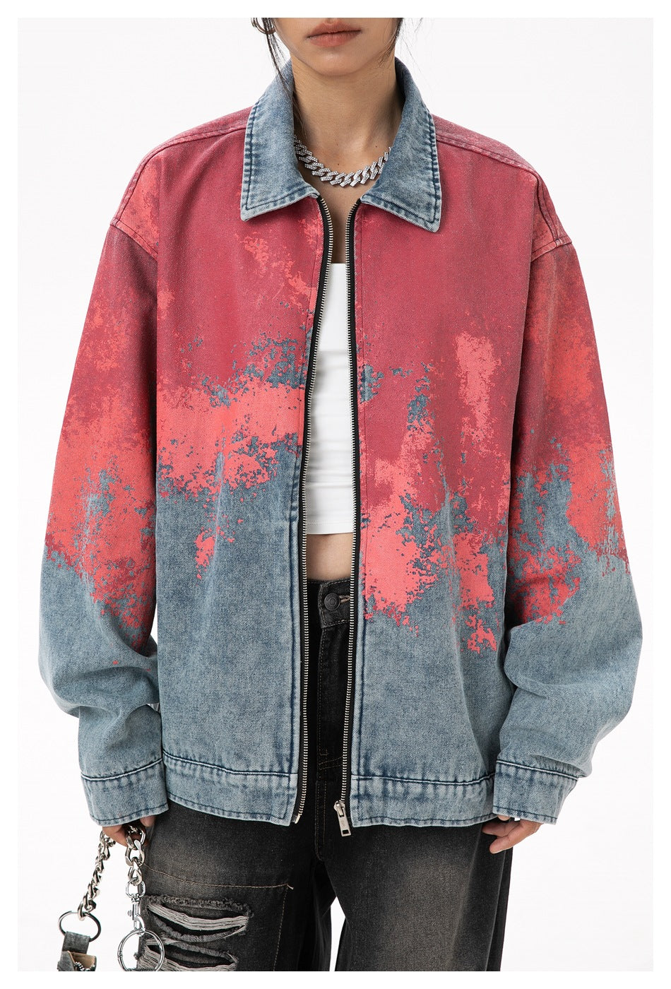 Model wearing an oversized red and blue distressed denim zip jacket with a contrasting blue collar, shown from the front.