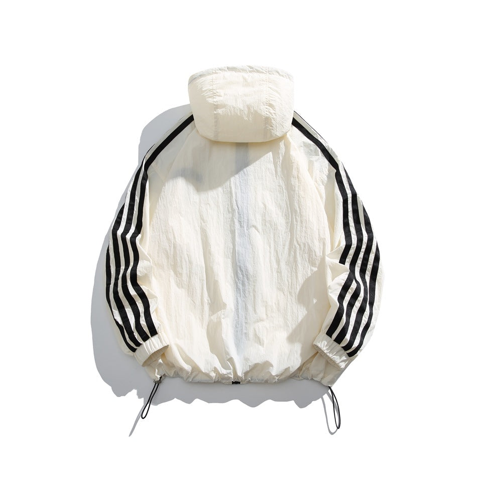 Back view of cream-white hooded jacket with black sleeve stripes, crinkled fabric and hem drawcord toggles