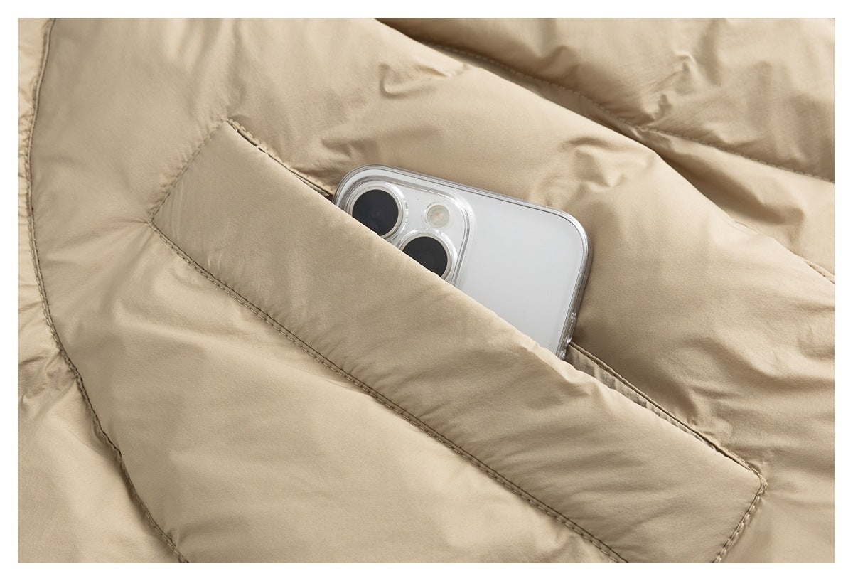 Close-up of a beige padded jacket pocket with a smartphone tucked inside.