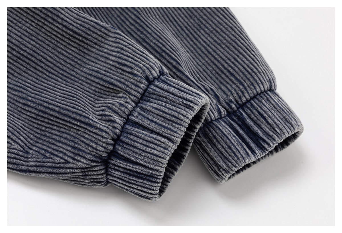 Close-up of folded blue-gray ribbed corduroy cuffs and sleeve seams.