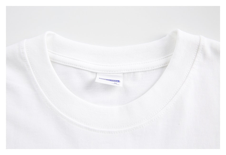 Close-up of a white T-shirt’s ribbed crew neck and inner neck label.
