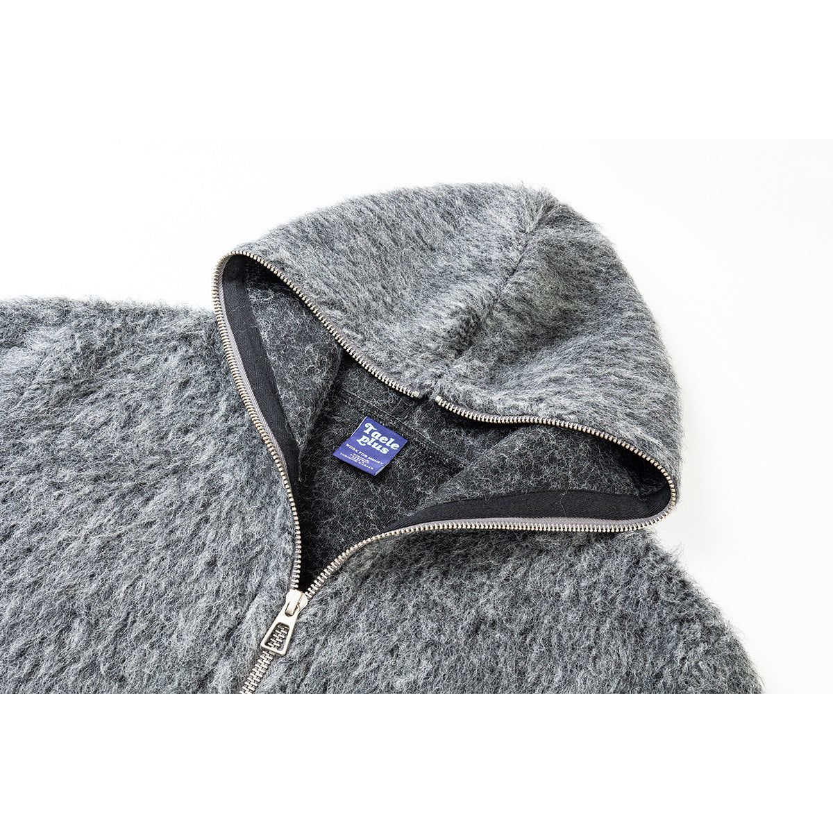 Close-up of the gray jacket's hood, dark lining, zipper trim, and sewn-in label.