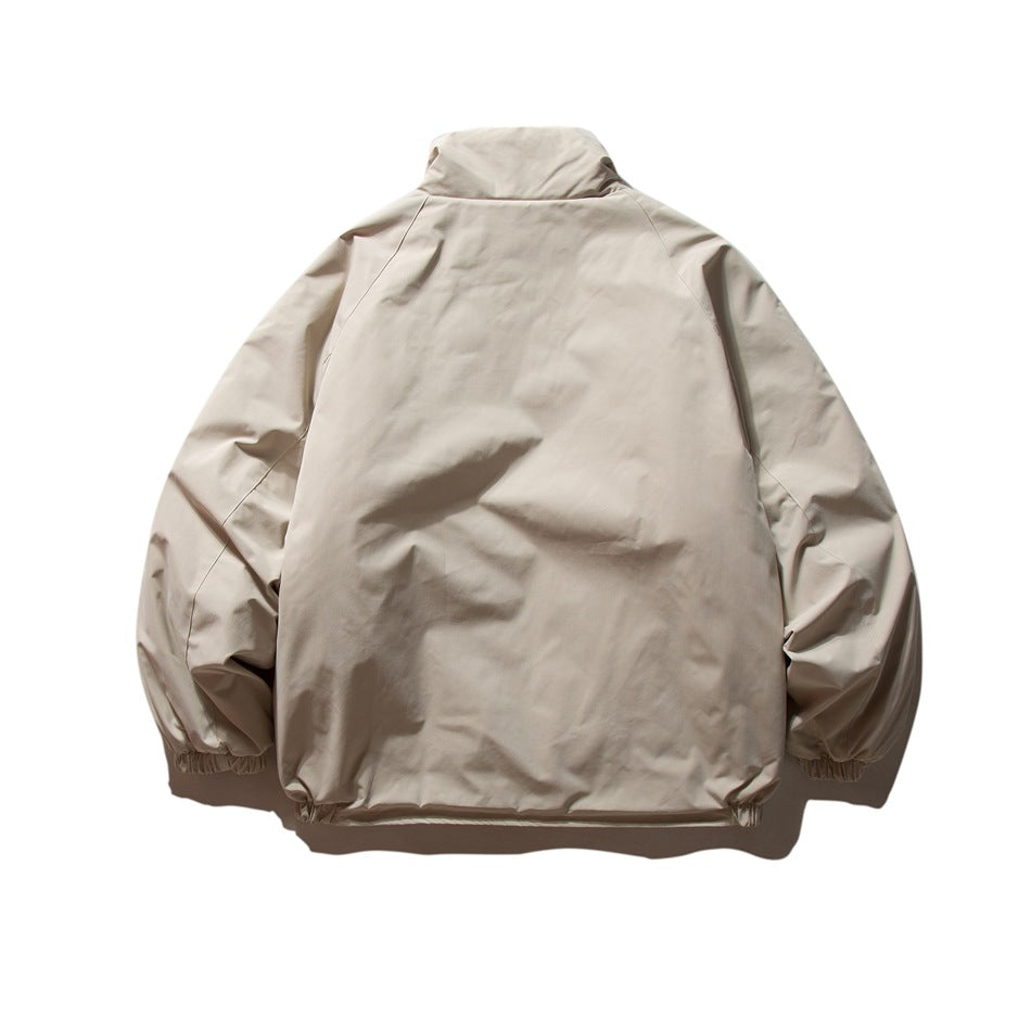 Back view of beige stand-collar jacket with raglan sleeves and elasticated cuffs and hem, flat lay