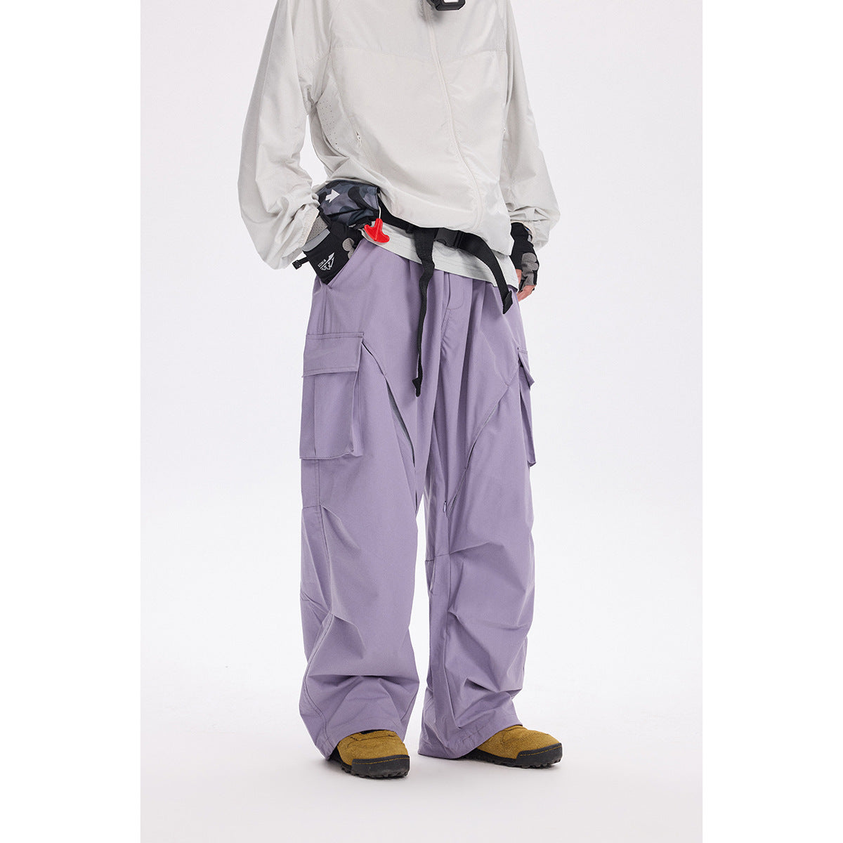 Model wearing loose lavender cargo pants with flap pockets and a white jacket.