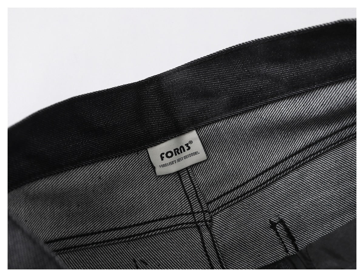 Inside view of black pants with a sewn-in FORN3 label at the waistband.