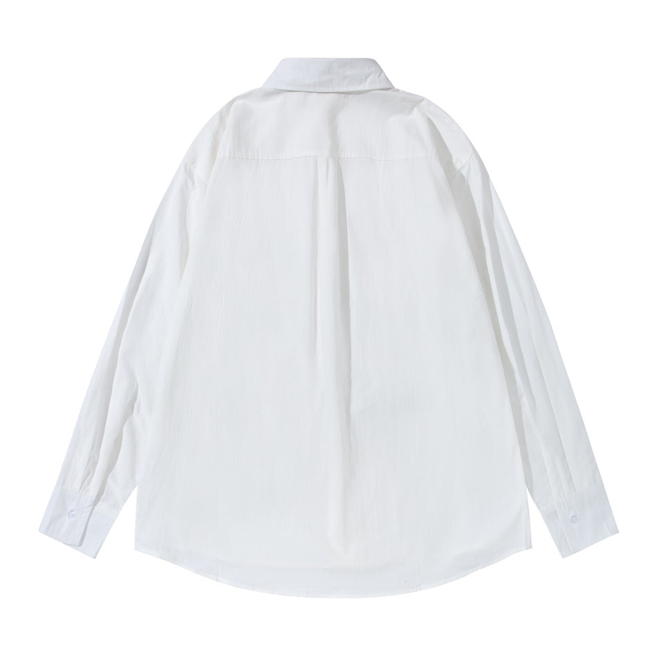 Back view of a white long-sleeved button-up shirt laid flat, showing a yoke seam and center pleat.