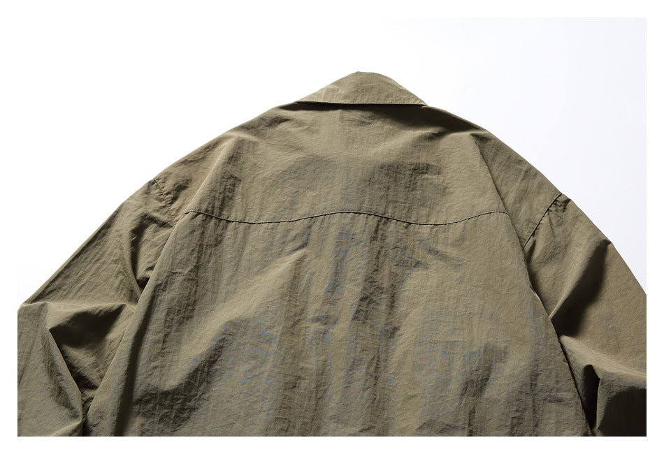 Upper back of an olive-brown shirt, showing its collar, shoulder seams, and horizontal yoke seam.