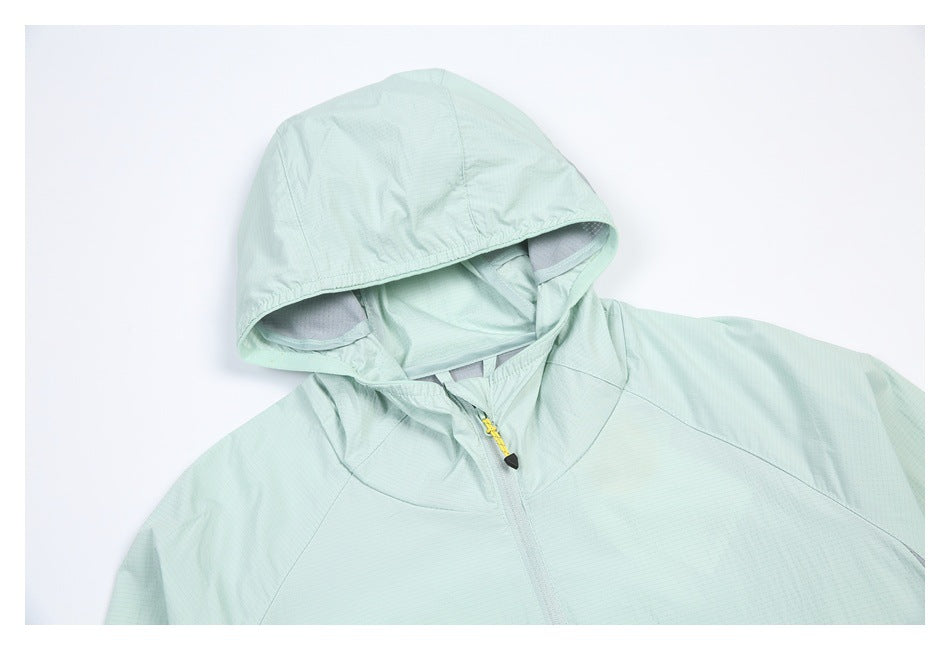 Close view of a mint jacket’s hood, collar, and upper front zipper with a yellow cord pull.