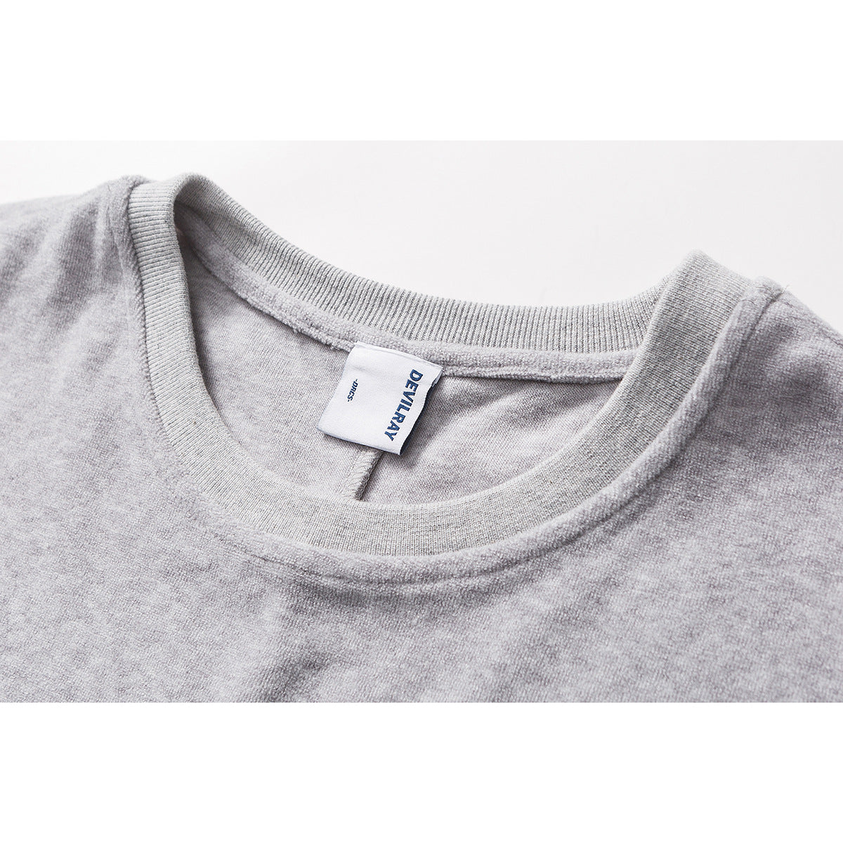 Close-up of a heather-gray crew neck with ribbed trim and a sewn-in DEVILRAY label.