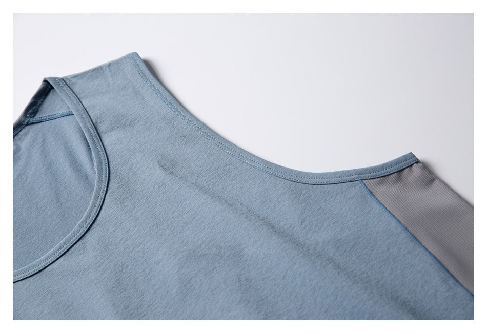 Close-up of the blue-gray top's shoulder seam and gray mesh panel.