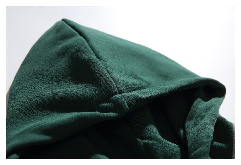 Close-up of the dark green hood and its stitched panel seams.