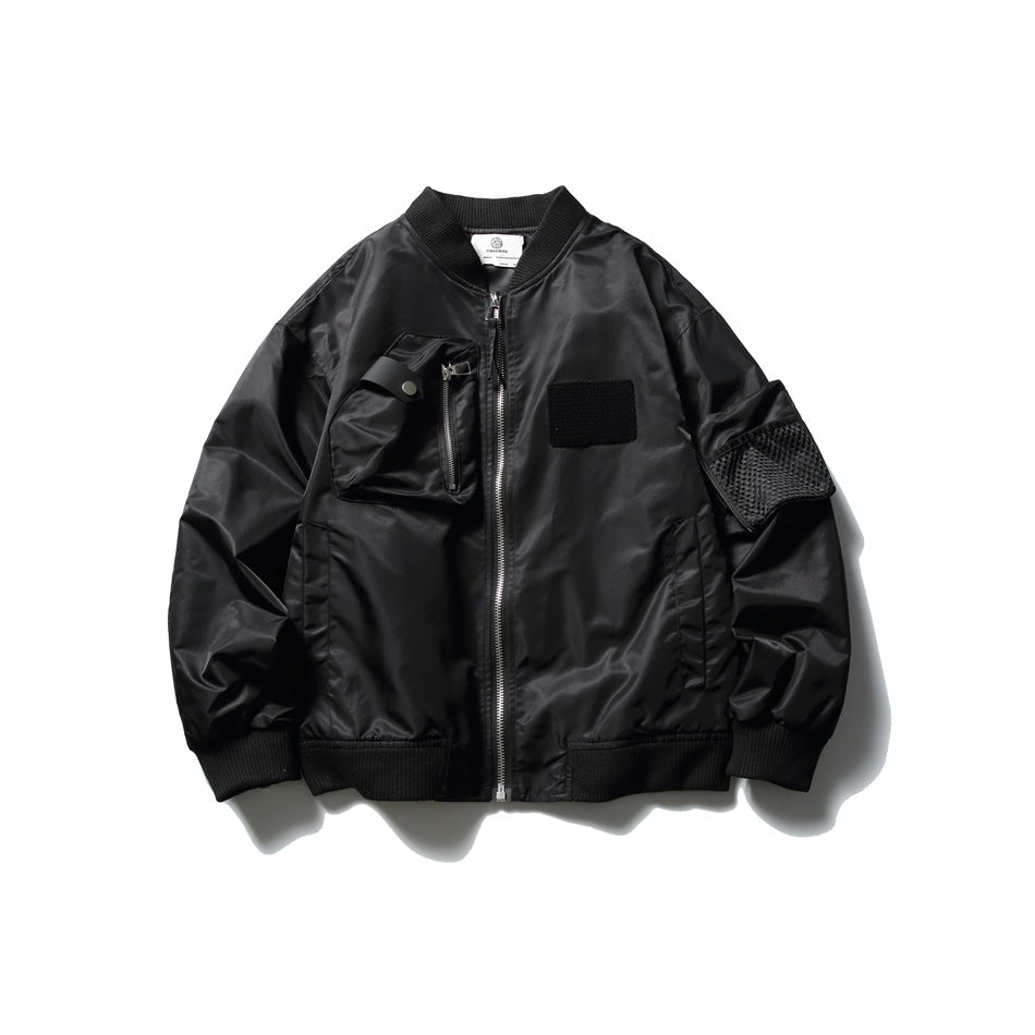 Black bomber jacket flat lay with ribbed collar, front zipper, chest zip pocket, chest patch and mesh sleeve pocket