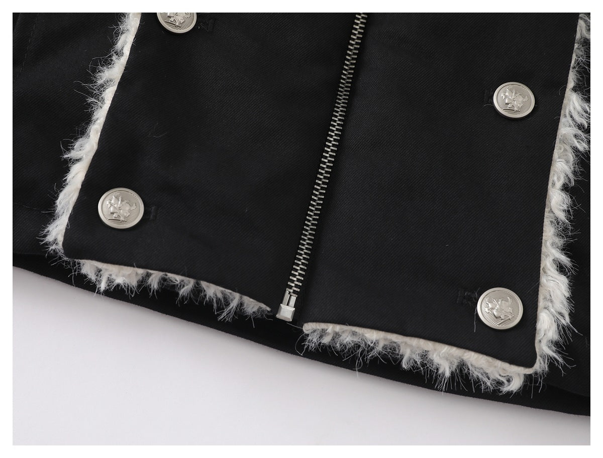 Close-up of the black coat's zipper and silver buttons, with fluffy white trim along the front panel edges.