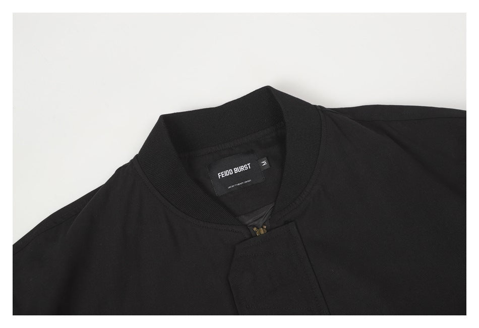Close-up of the black jacket's ribbed collar, front closure, and sewn-in neck label.
