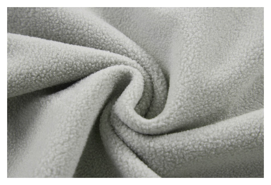 Close-up of plush gray fabric gathered into a curl.