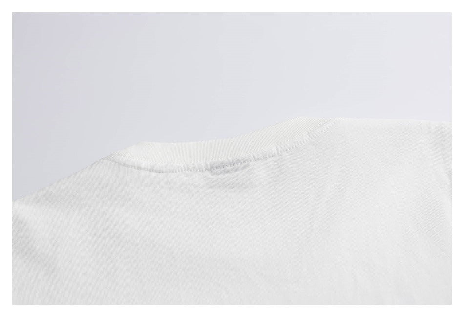 Close-up of the stitched crew neckline on a plain white shirt.
