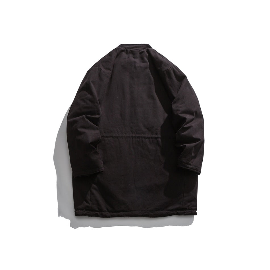 Back view of a dark long coat with a smooth exterior, long sleeves and a horizontal seam across the back.