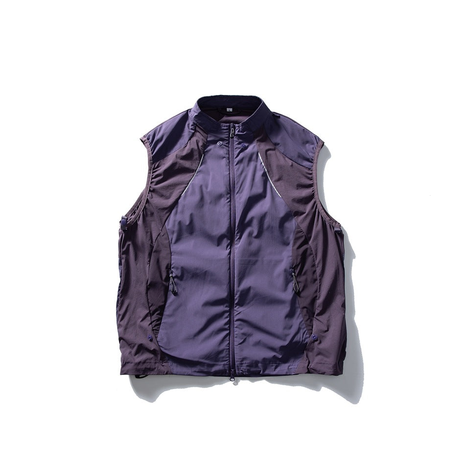 Front view of a plum-purple sleeveless zip vest with a stand collar, pockets, and contrasting panels.