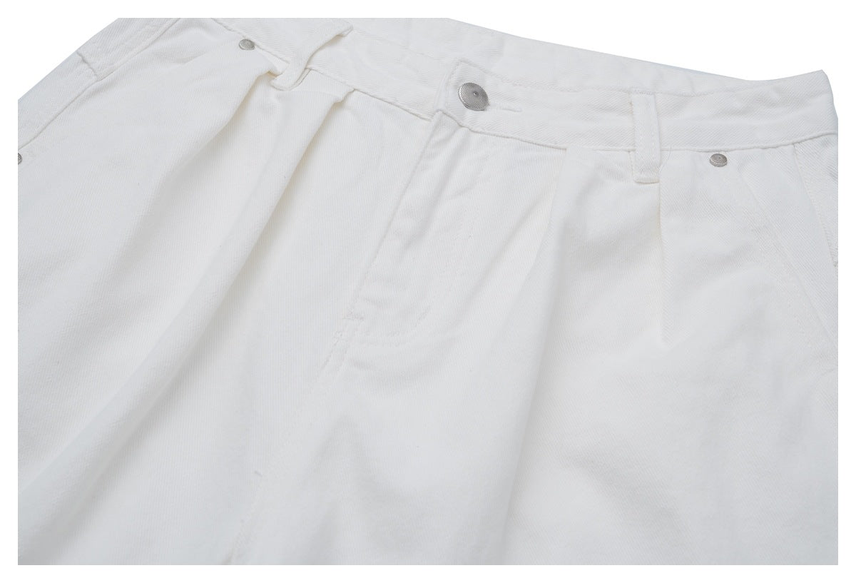 Close-up of the front waistband of white trousers, showing a metal button, belt loops, and pocket.